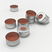 Group of silver 11 mm crimp caps showing red-orange septa and open undersides