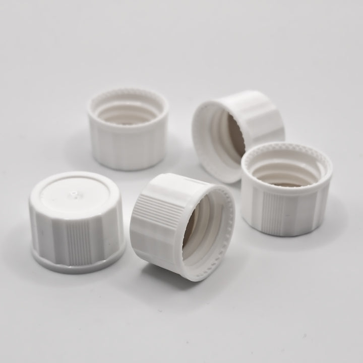 Group of white 18-400 closed-top polypropylene screw caps showing threaded interiors