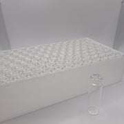 Clear 20 mL crimp headspace vials arranged in a storage tray